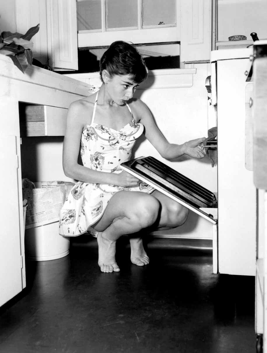 A black and white vintage photo of a woman before damage repair and enhancement